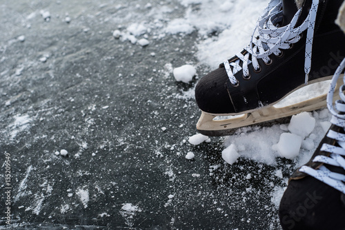 hockey scates on ice pond riwer photo