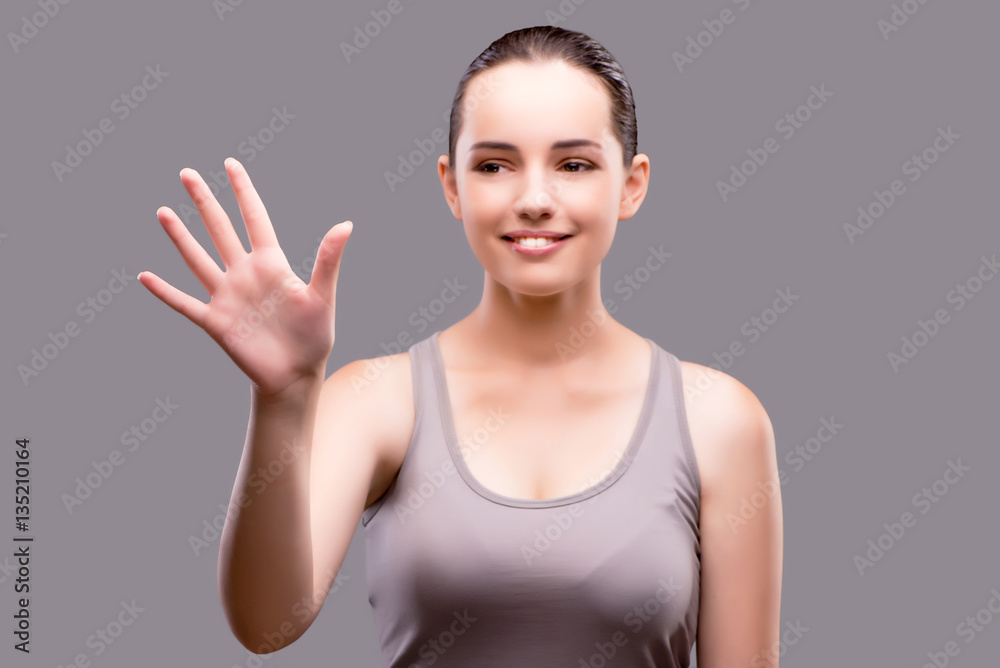 Young sports girl pressing virtual button Young sports girl pressing virtual button