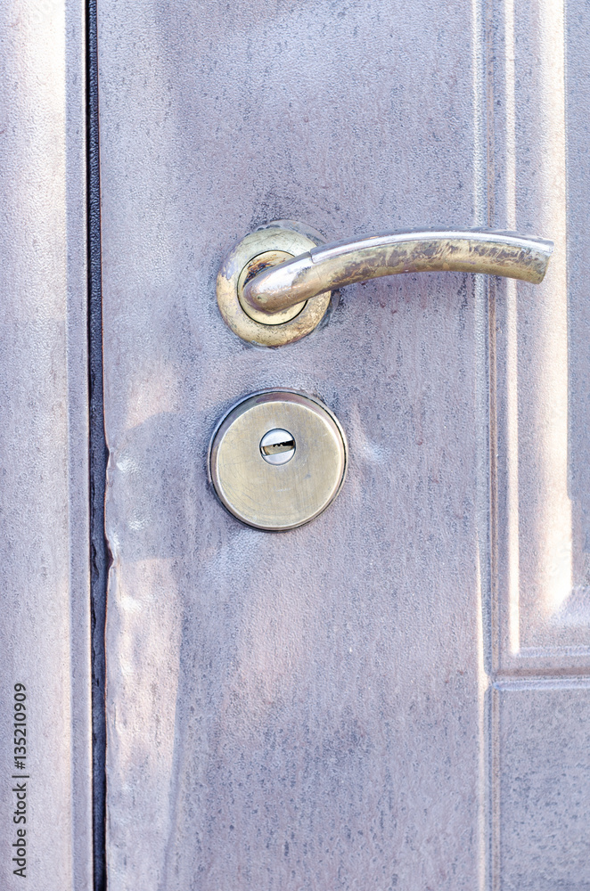 Metal door with traces of burglary with lock and door handle Metal door with traces of burglary with lock and door handle