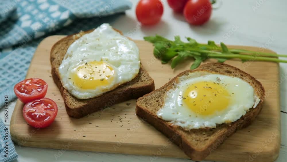 Healthy Breakfast: scrambled eggs on slices of whole-grain bread with arugula and tomatoes on a wooden Board Healthy Breakfast: scrambled eggs on slices of whole-grain bread with arugula and tomatoes on a wooden Board