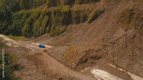 Landslides and rockfalls on the road in the mountains.Aerial view: mud and rocks blocking the road.Destroyed rural road landslide damaged in powerful flood. Collapsed on the mountain. Philippines photo