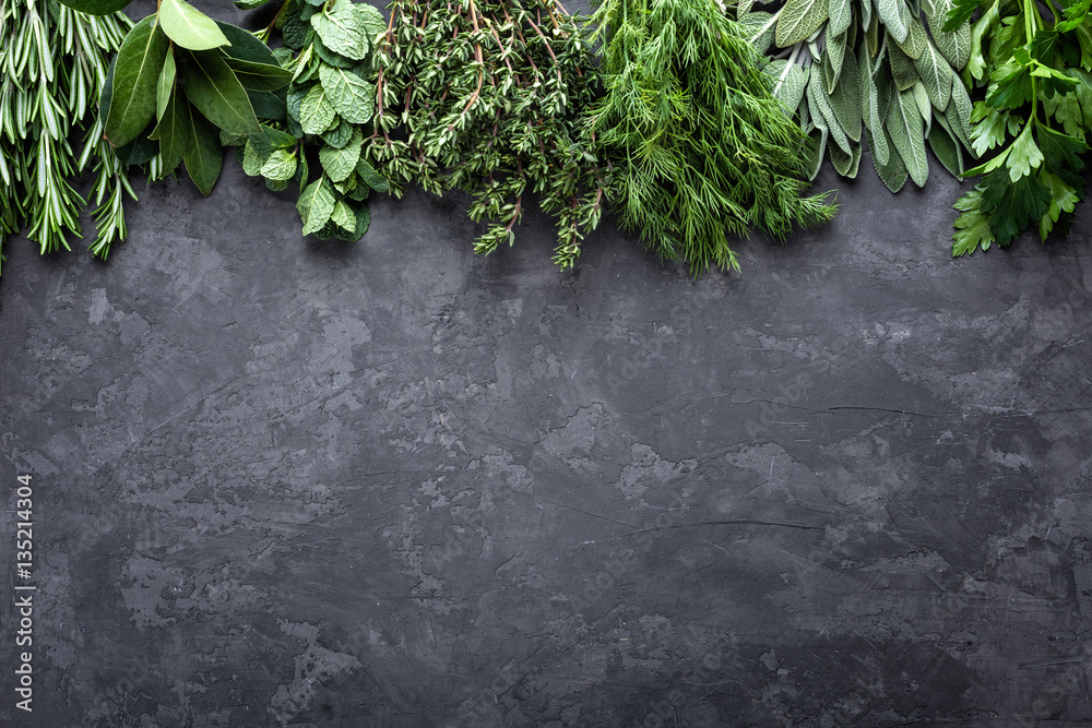 fresh herbs on dark stone background with space for text - obrazy, fototapety, plakaty 