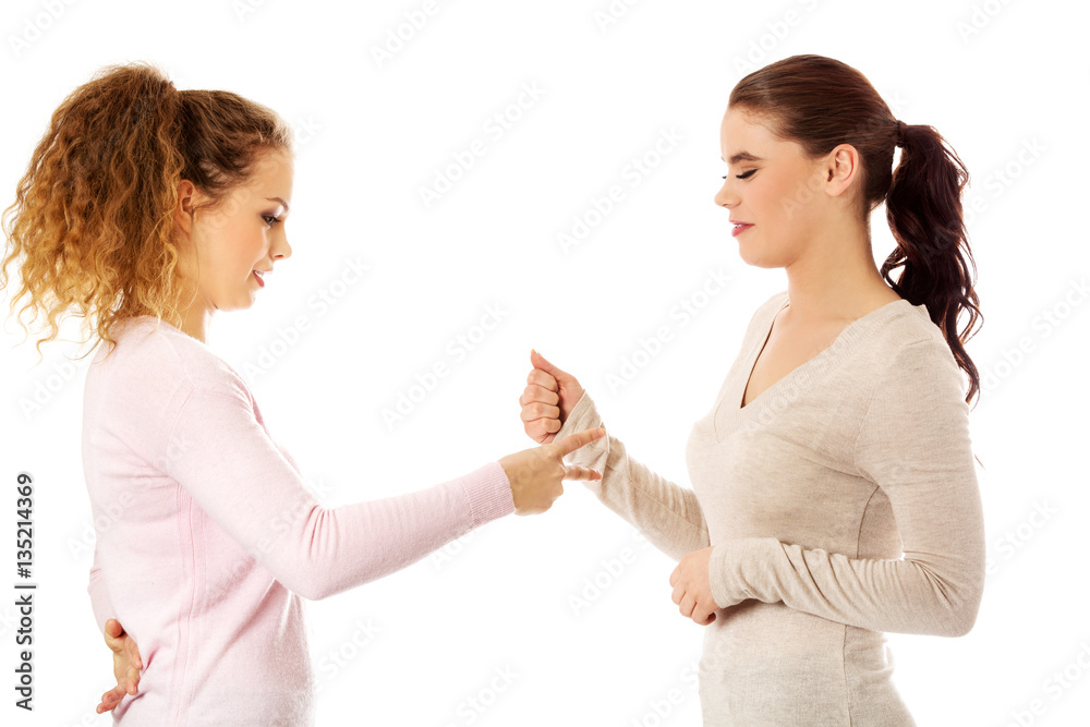 Two young girl friends standing together. Two young girl friends standing together.
