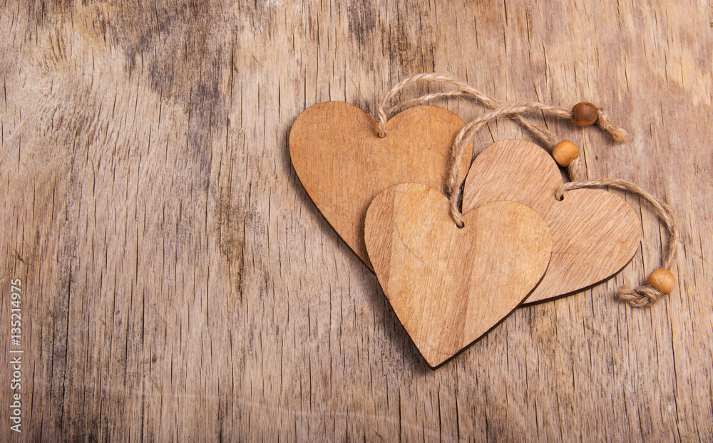 Hearts made of wood in the old worn wooden background. Wooden valentine. Valentine's day. Copy space Hearts made of wood in the old worn wooden background. Wooden valentine. Valentine's day. Copy space