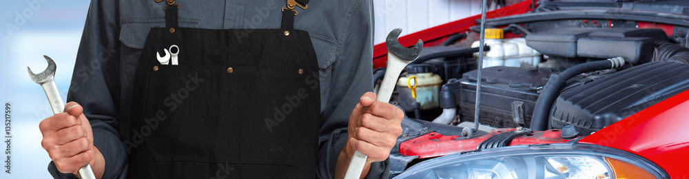 Hands of car mechanic with wrench