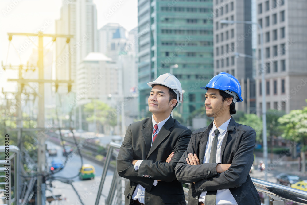 smart businessman or foreman standing arm fold hands when buildi smart businessman or foreman standing arm fold hands when buildi