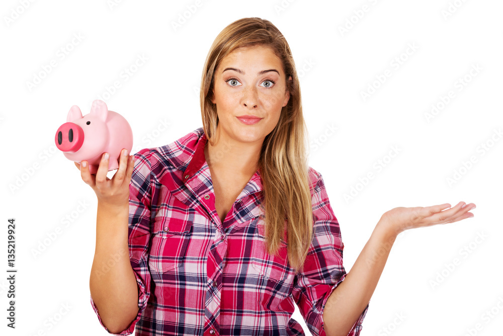 Obraz premium Young woman holding piggybank and gesturing dont know