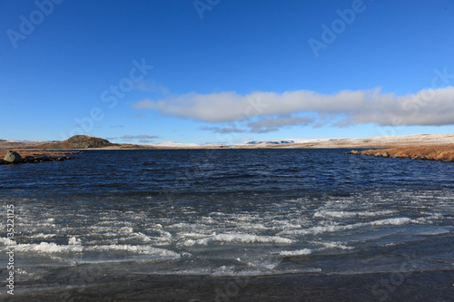 A cold autumn day with ice on the water on Hardangervidda, Norway