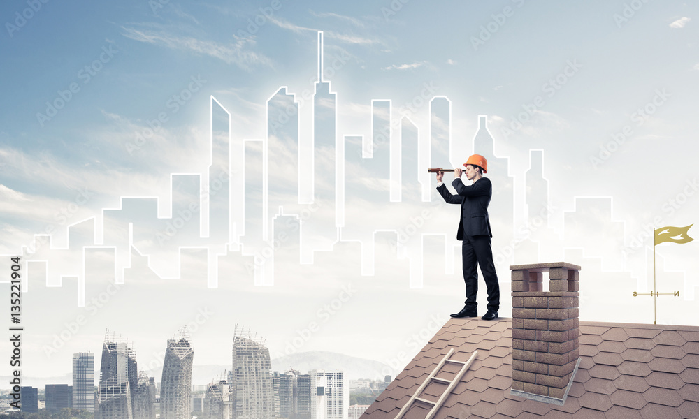 Engineer man standing on roof and looking in spyglass. Mixed med Engineer man standing on roof and looking in spyglass. Mixed med