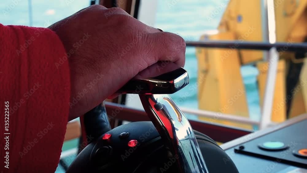Tug master controls motors. Close-up of hands in a low light