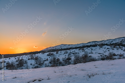 Beautiful winter mountain sunset with a breathtaking orange sky. Russia, Stary Krym.