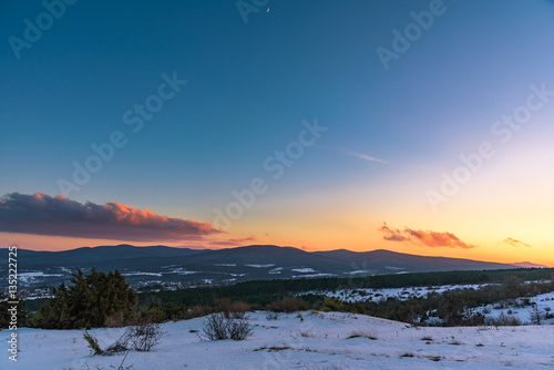 Colorful winter sunset on the mountain background with a spectacular sky. Russia, Stary Krym.