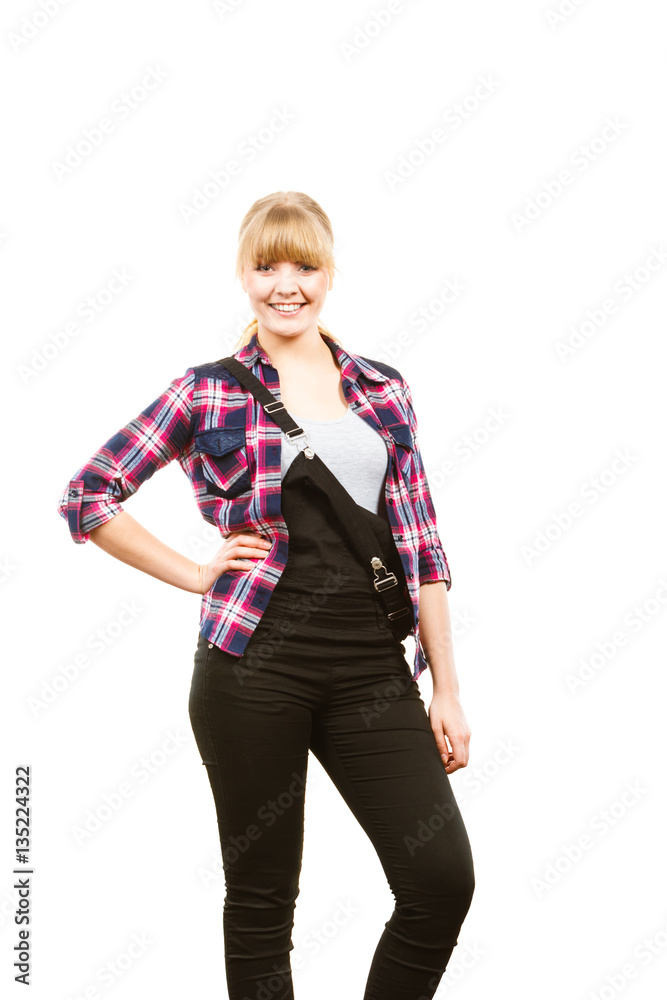 Smiling standing woman wearing dungarees and shirt Smiling standing woman wearing dungarees and shirt