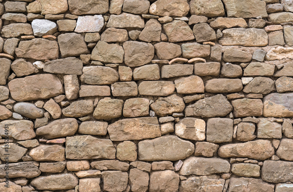 Old stone wall stones fitted together without cement, carved by hand