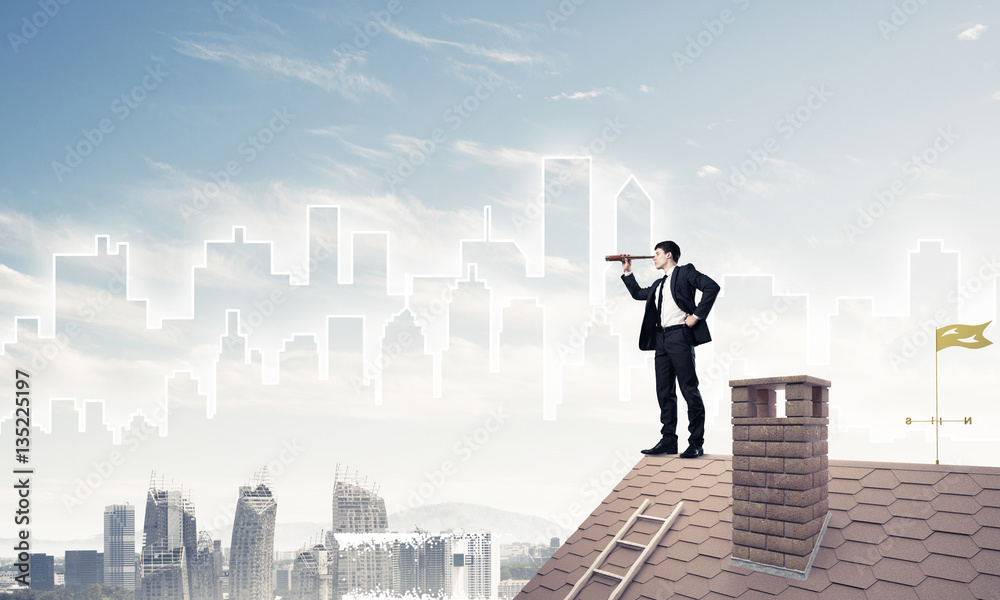 Engineer man standing on roof and looking in spyglass. Mixed med Engineer man standing on roof and looking in spyglass. Mixed med