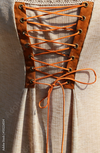 intertwining with the string of an ancient medieval dress in cot photo