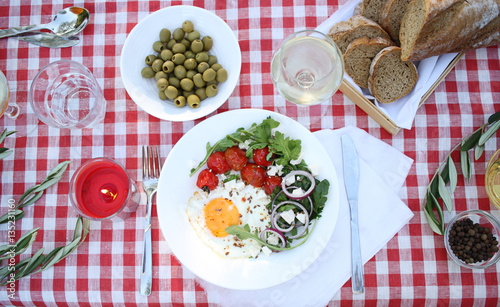 Romantic picnic. Outdoor meal with eggs, tomatoes and glass of wine. Flat lay