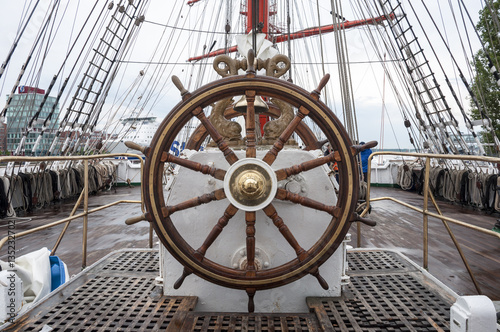 Wooden steering wheel of the sailboat.