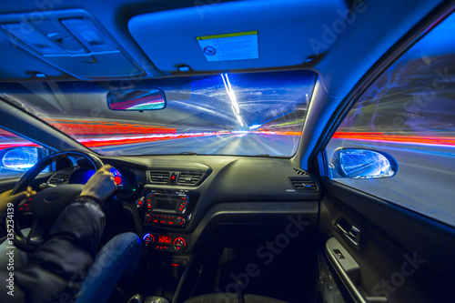 The car moves at great speed.Blured road with lights with car on high speed. Concept rapid rhythm of a modern city. © pozdeevvs