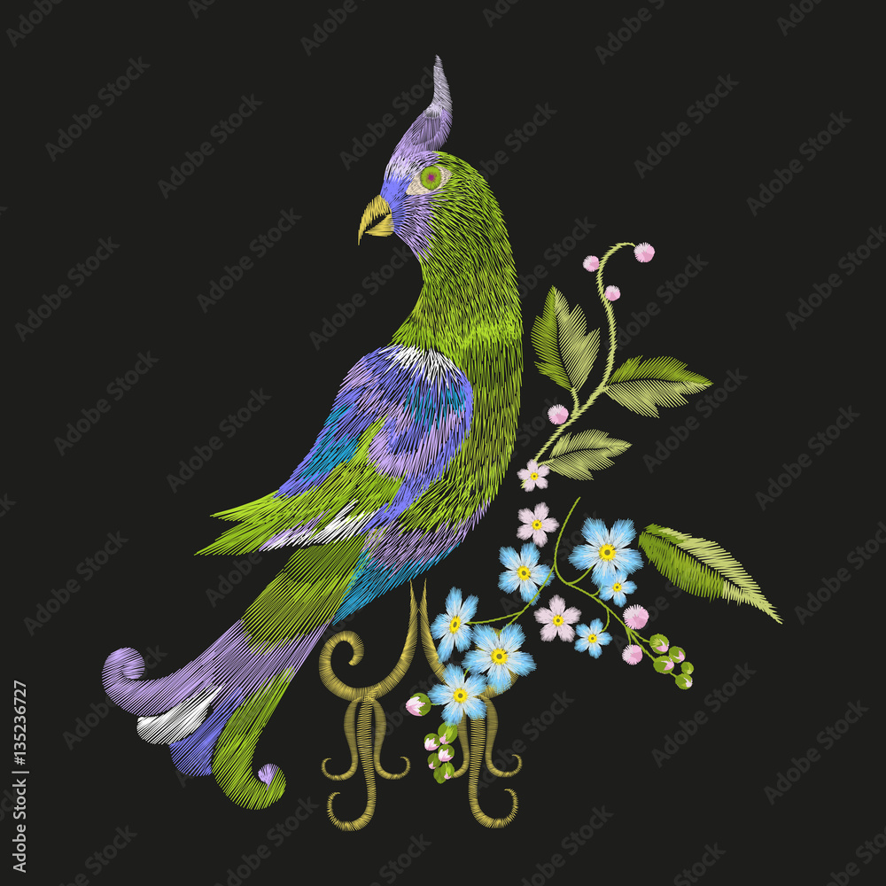Naklejka premium Embroidery colorful floral pattern with fantasy parrot. Vector trend folk green bird with flowers ornament on black background.