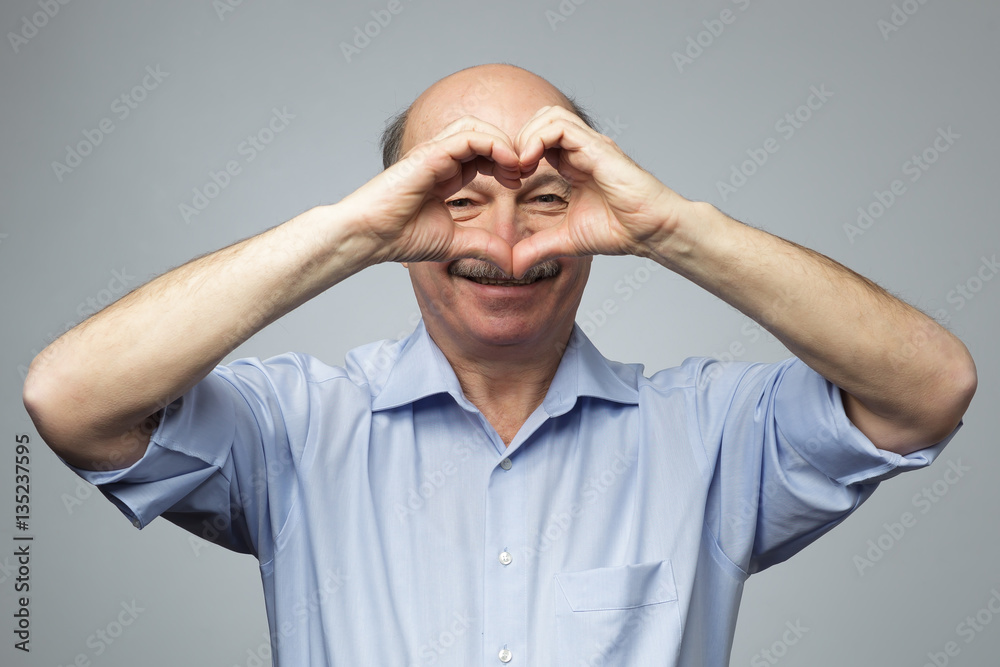 old man making out of hands heart. Doing charity work, take care old man making out of hands heart. Doing charity work, take care