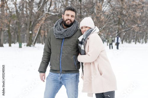 Loving couple enjoying the snow in the park