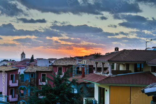 sunset between houses in Badesi  photo