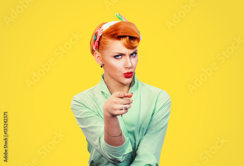 It's you! Portrait angry annoyed pin up retro style woman getting mad pointing finger at you photo