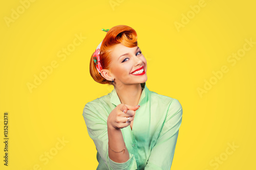 portrait of a beautiful woman pinup retro style pointing at you smiling laughing