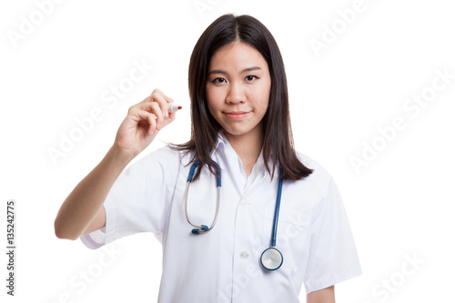 Young Asian female doctor write with a red marker.