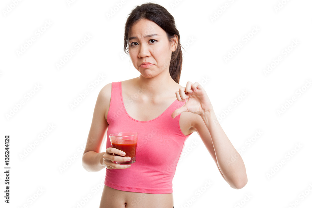 Beautiful healthy Asian girl hate tomato juice thumbs down. Beautiful healthy Asian girl hate tomato juice thumbs down.