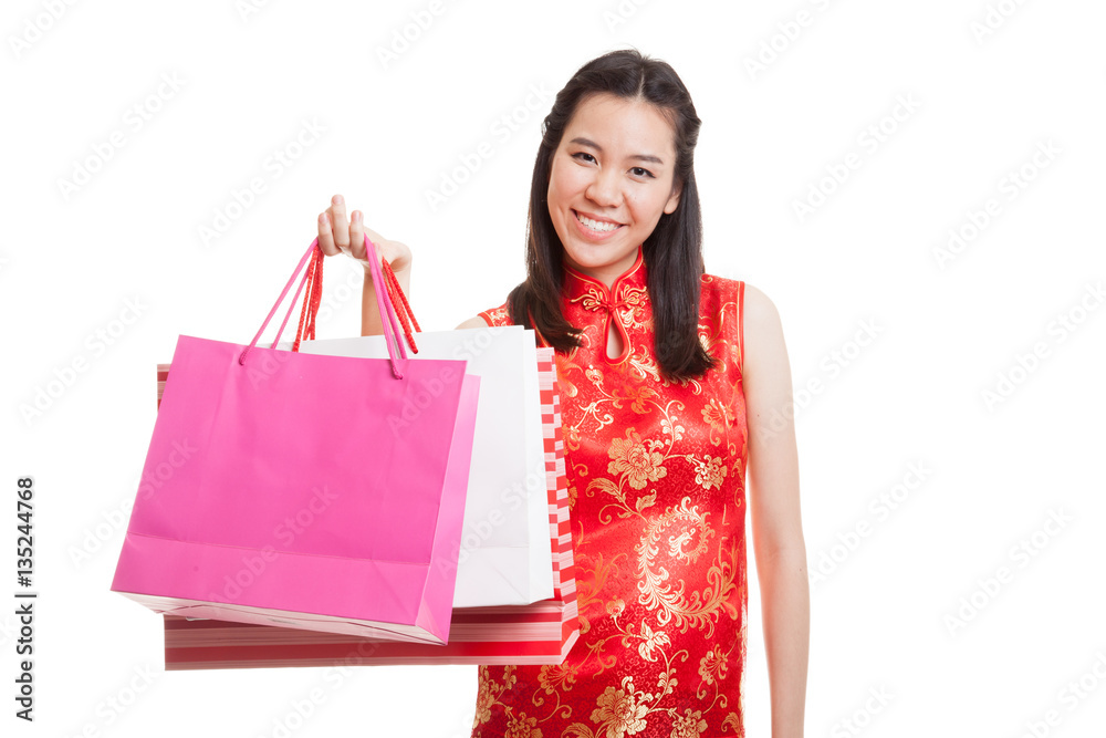 Asian girl in chinese cheongsam dress with shopping bag.