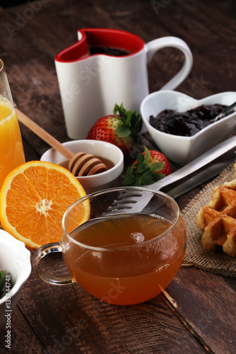 breakfast on table with waffles, croissants, coffe and juice