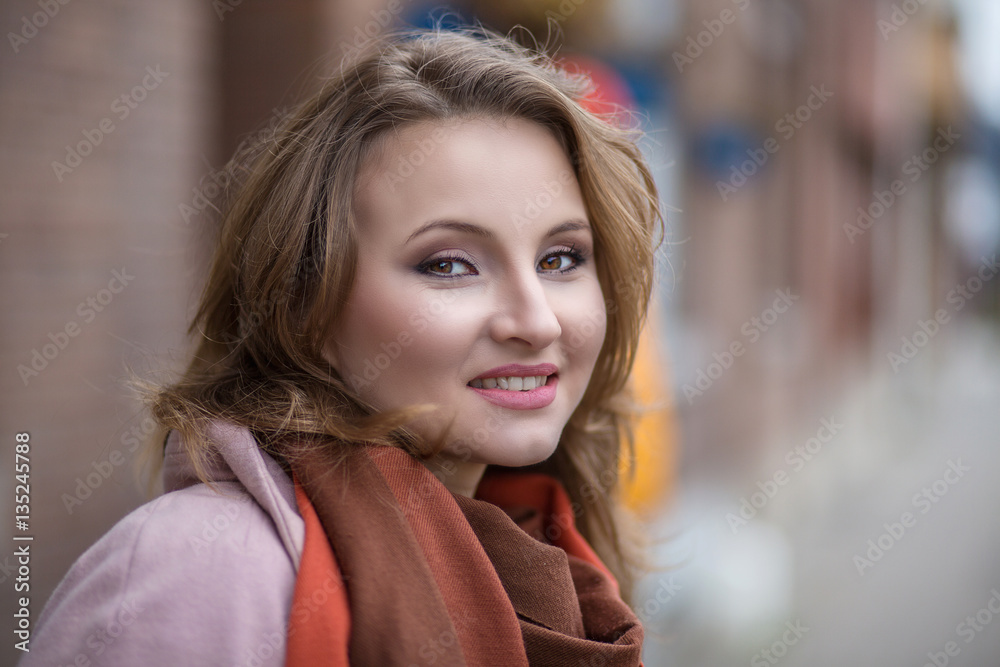 Smiling beautiful young business woman in warm clothing enjoying time outdoors Smiling beautiful young business woman in warm clothing enjoying time outdoors