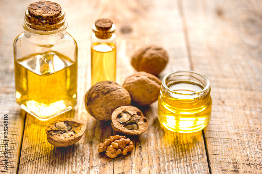cosmetic and therapeutic walnut oil on wooden background cosmetic and therapeutic walnut oil on wooden background