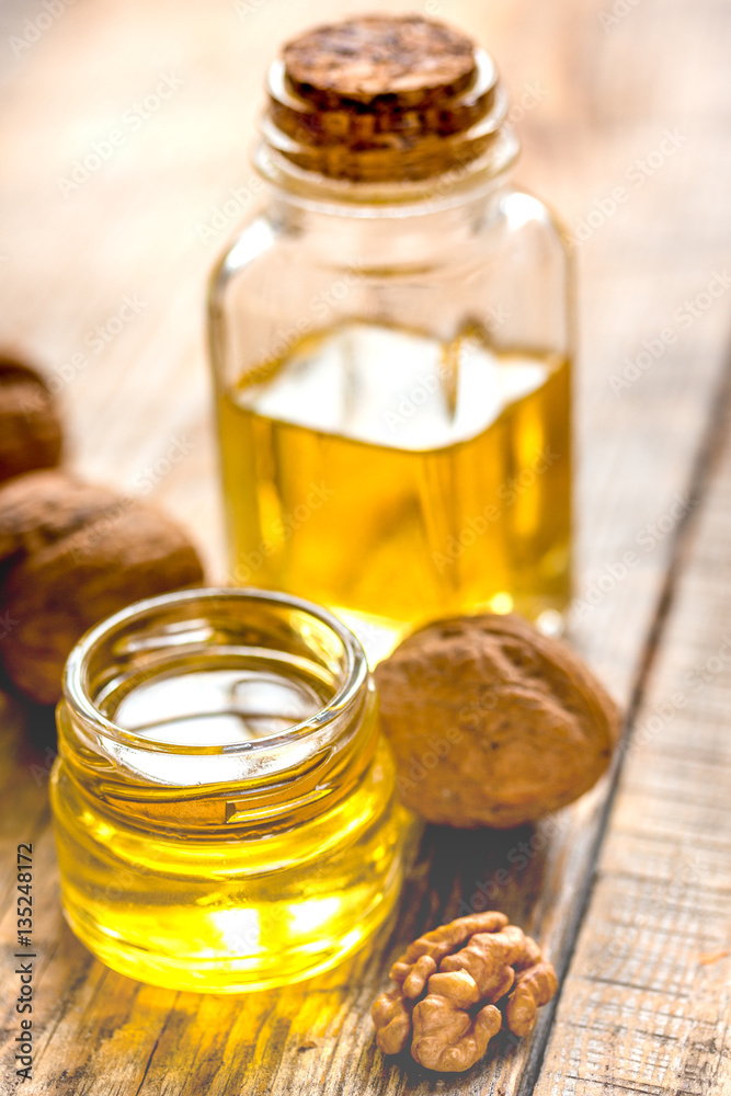 cosmetic and therapeutic walnut oil on wooden background cosmetic and therapeutic walnut oil on wooden background
