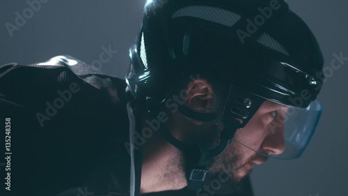 CU Caucasian male ice hockey player in black uniform preparing for a face-off puck drop. 4K UHD 60 FPS slow motion. RAW edited footage
