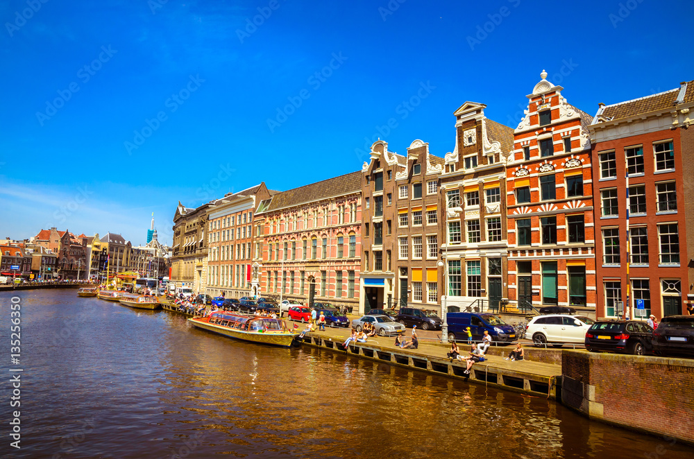 Traditional old buildings and and boats in Amsterdam, Netherland