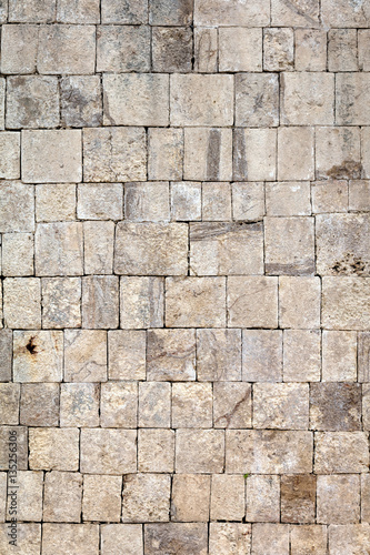 Ancient Mayan stone wall of the Great Ball Court in Chichen Itza