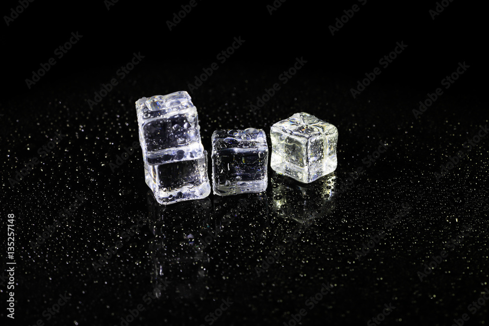 ice cubes reflection on black table background. ice cubes reflection on black table background.