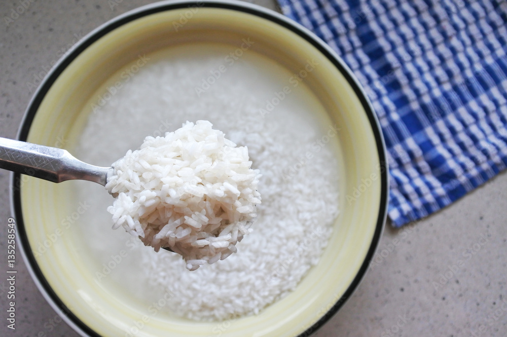 Flat lay view of spoon full of white ric Flat lay view of spoon full of white ric