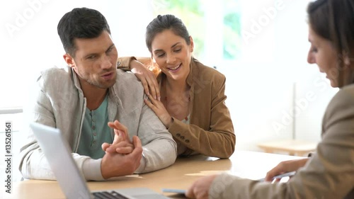 Couple meeting financial adviser for contract signature