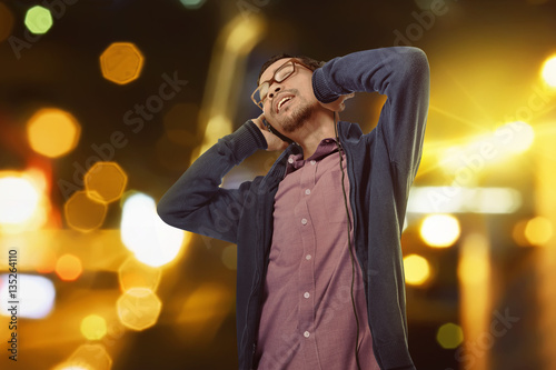 Handsome asian man listening music with handphone