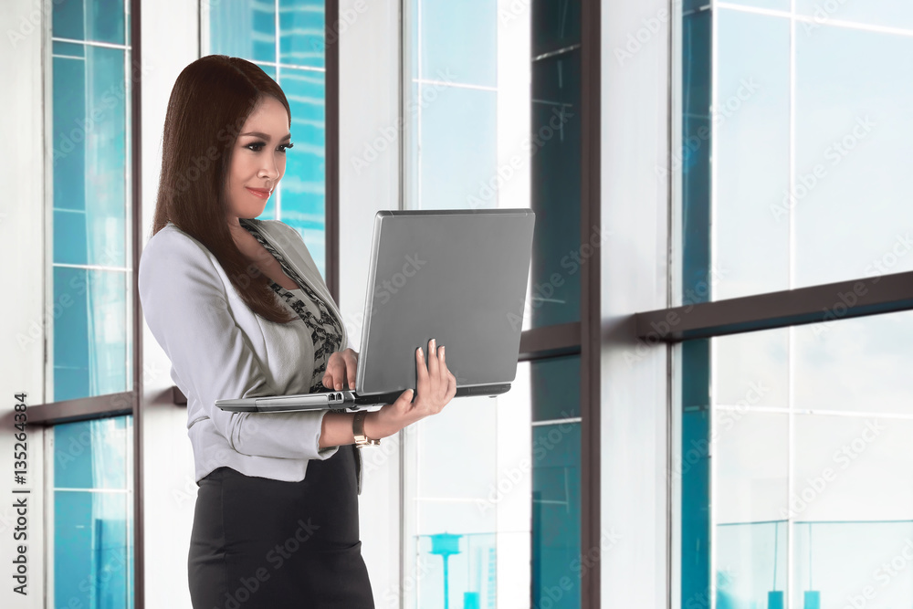 Beautiful asian business woman working with the laptop Beautiful asian business woman working with the laptop