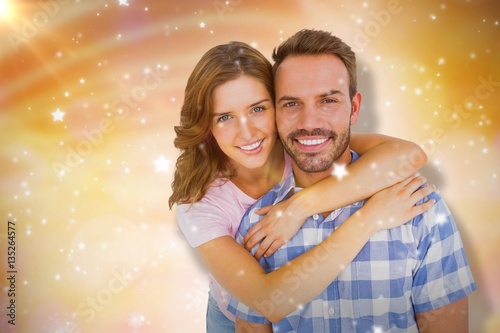 Composite image of happy young couple embracing