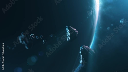3D animation of asteroids flying through solar system with planet and blue light in the background photo