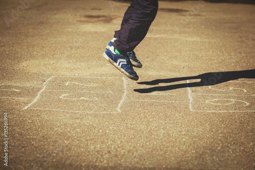 kid playing hopscotch on playground outdoors © nadezhda1906
