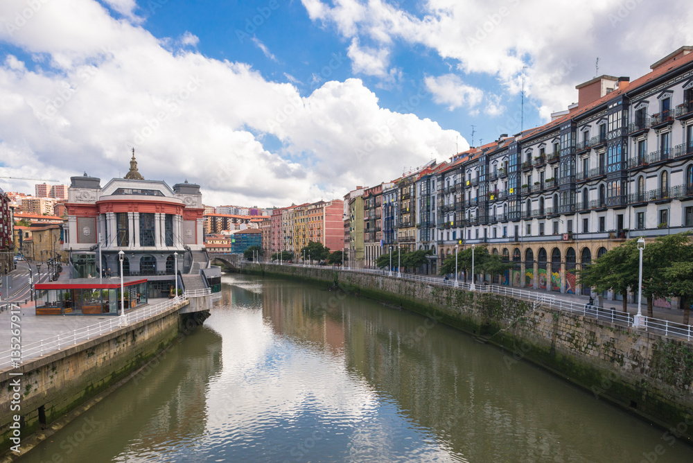 House facades in Bilbao along the Nervion river that runs through the city into the Cantabrian Sea. The apartment blocks are situated in the district San Frantzisko, on left the Mercado de la Ribera House facades in Bilbao along the Nervion river that runs through the city into the Cantabrian Sea. The apartment blocks are situated in the district San Frantzisko, on left the Mercado de la Ribera