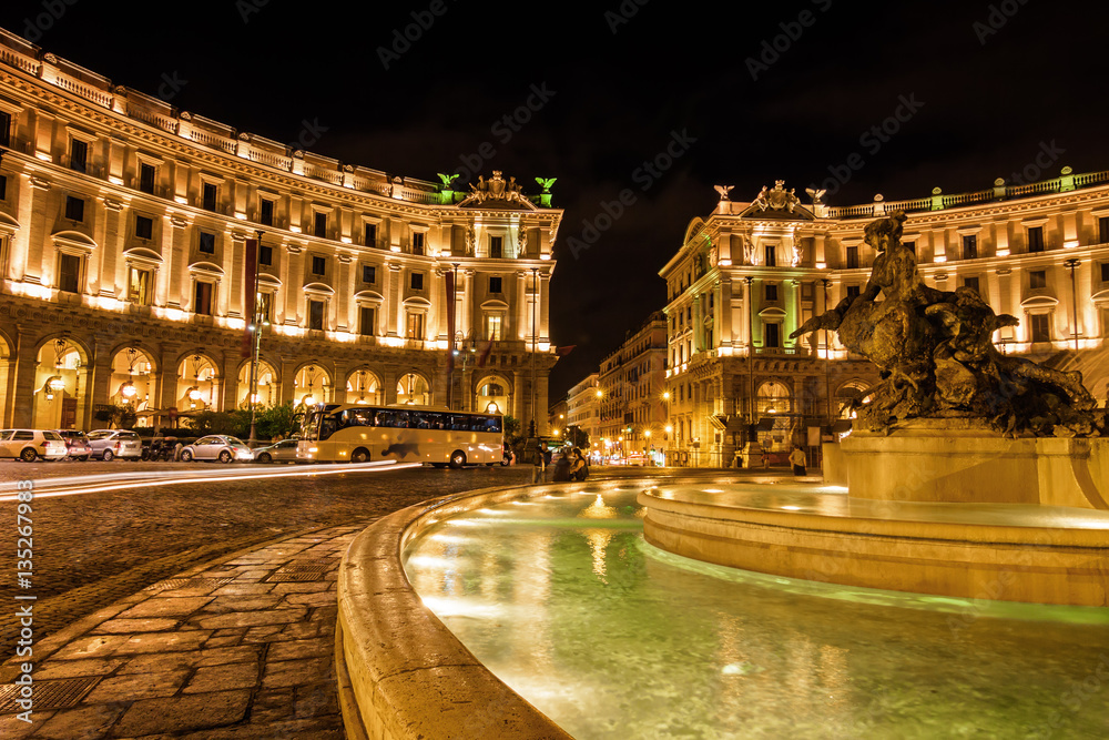 Night view of famous fountain with four bronze statues of the Naiads by Mario Rutelli, which stands in the center of Piazza della Repubblica in Rome, Lazio region, Italy.