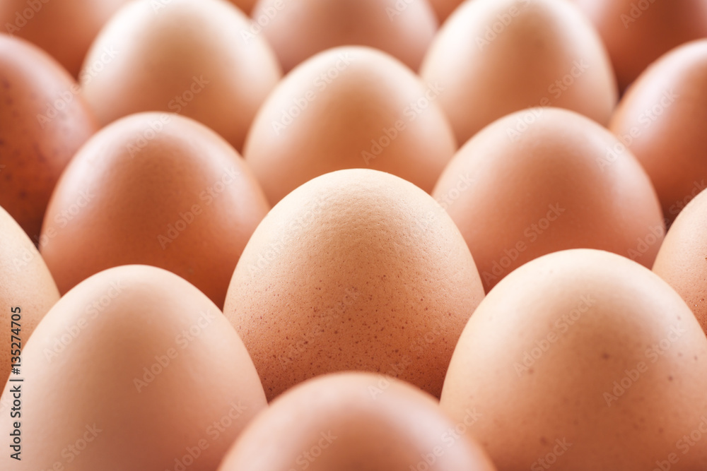 Eggs cooking for breakfast, a protein form yolk and albumen on a white background, or on a plain wooden table.